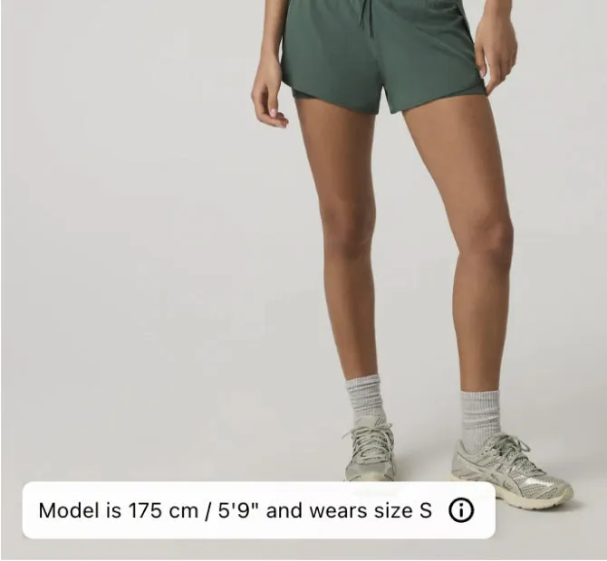 A model in green running shorts, with a caption along the bottom giving the model’s height, 175 cm, and the size worn, S.