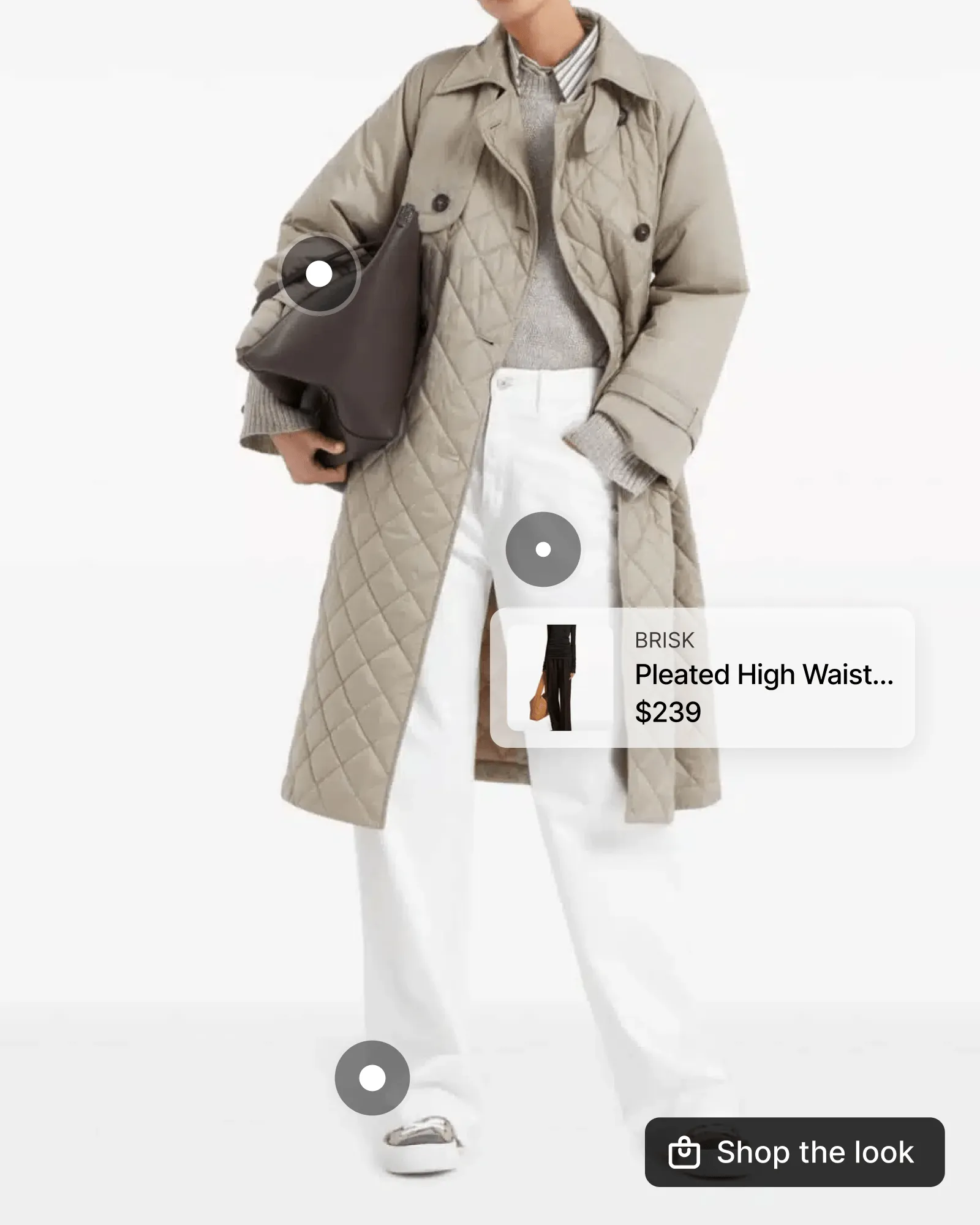 One gallery photo of a model in a quilted beige coat, white trousers and a dark shoulder bag. Three hotspots sit on the photo. The one on the trousers is open and shows a linked pair of pleated high-waist trousers at $239.