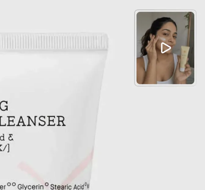 A face cleanser on a grey background, with a video button in the top corner, a thumbnail of someone trying the product with a play icon over it.
